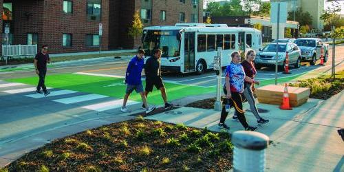 people walking in a cross walk